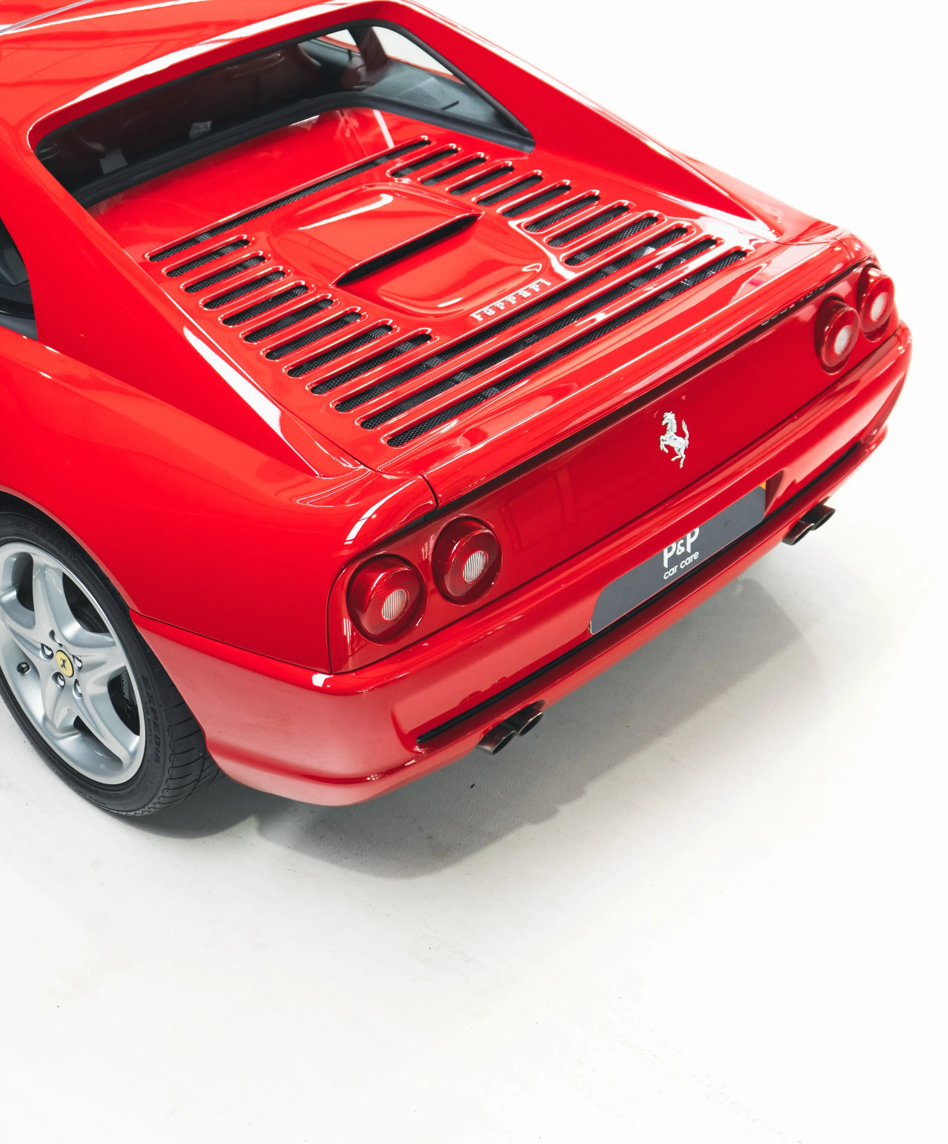 Achterzijde van de Ferrari F355 GTS met motorrooster en steigerend paard